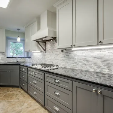 Gray cabinetry kitchen with mosaic tile backsplash