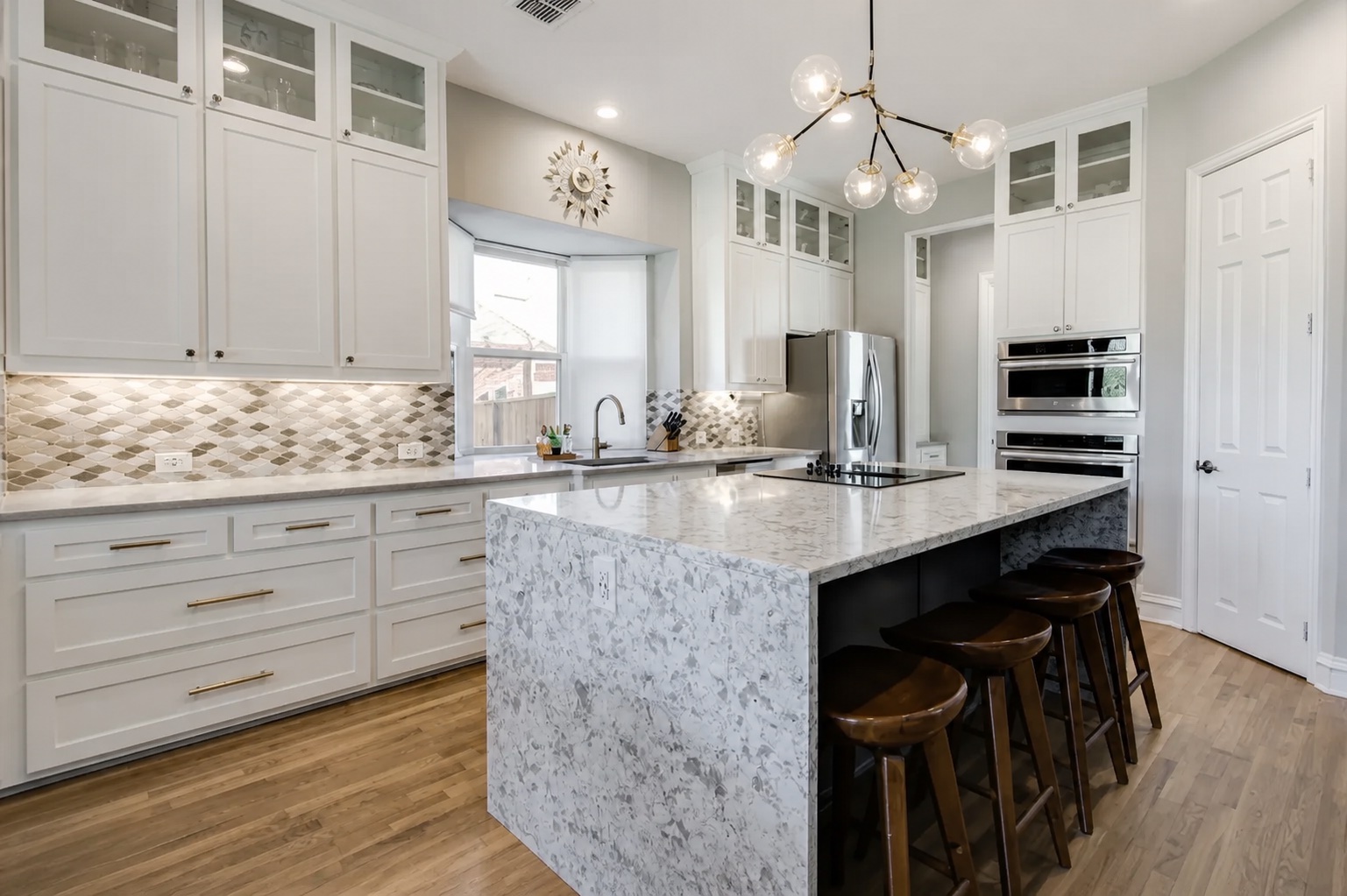 White kitchen with a waterfall-edge quartz island