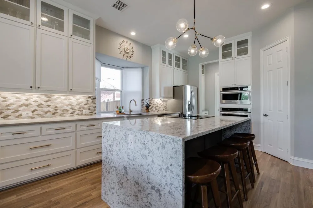 White kitchen with a waterfall-edge quartz island